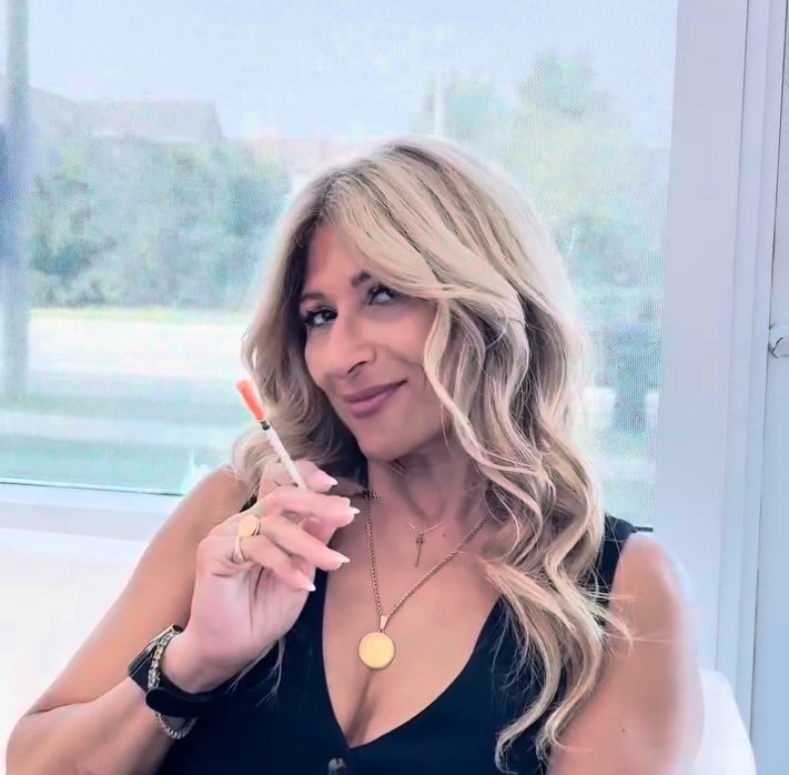 Randa holding a treatment syringe